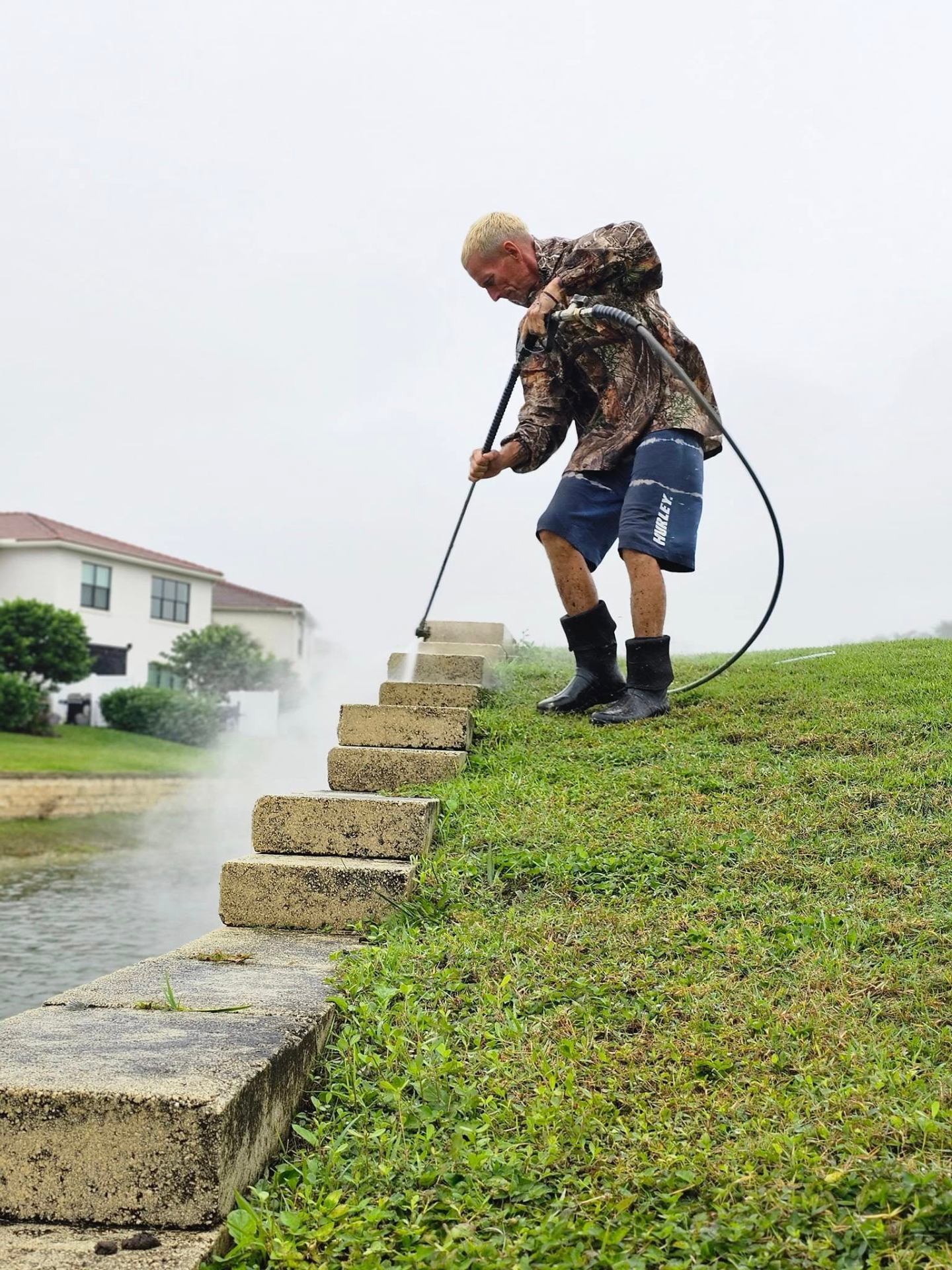Mike pressure cleaning a seawall in South Florida