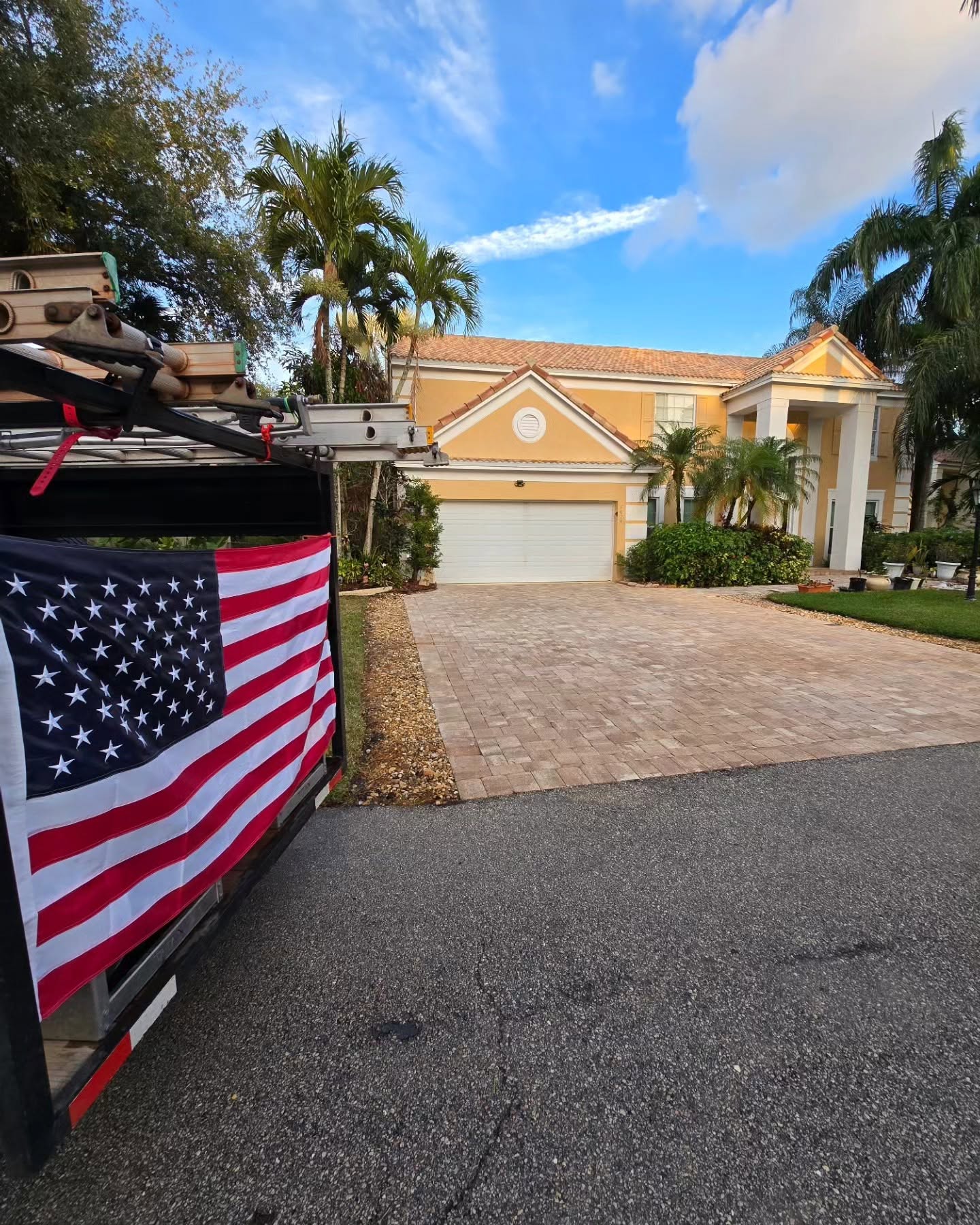 On Point Pressure Cleaning truck with USA flag on a driveway job